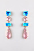 Close-up of Gleam Blue & Pink Drop Earrings, featuring ocean blue and blush pink crystals against a neutral background.