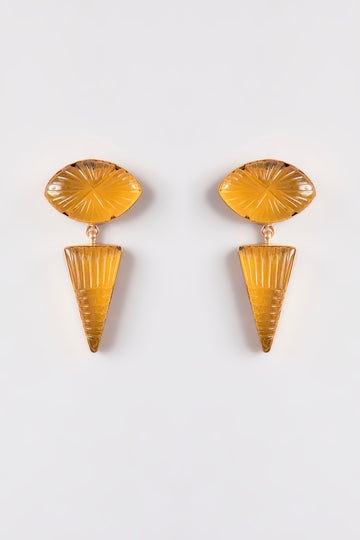 Flat-lay of the Golden Eye Drop Earrings, highlighting their unique eye-inspired shape and amber color.