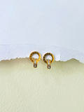 Simple gold earrings design with Roman-inspired crystal detailing placed on a clean white background.