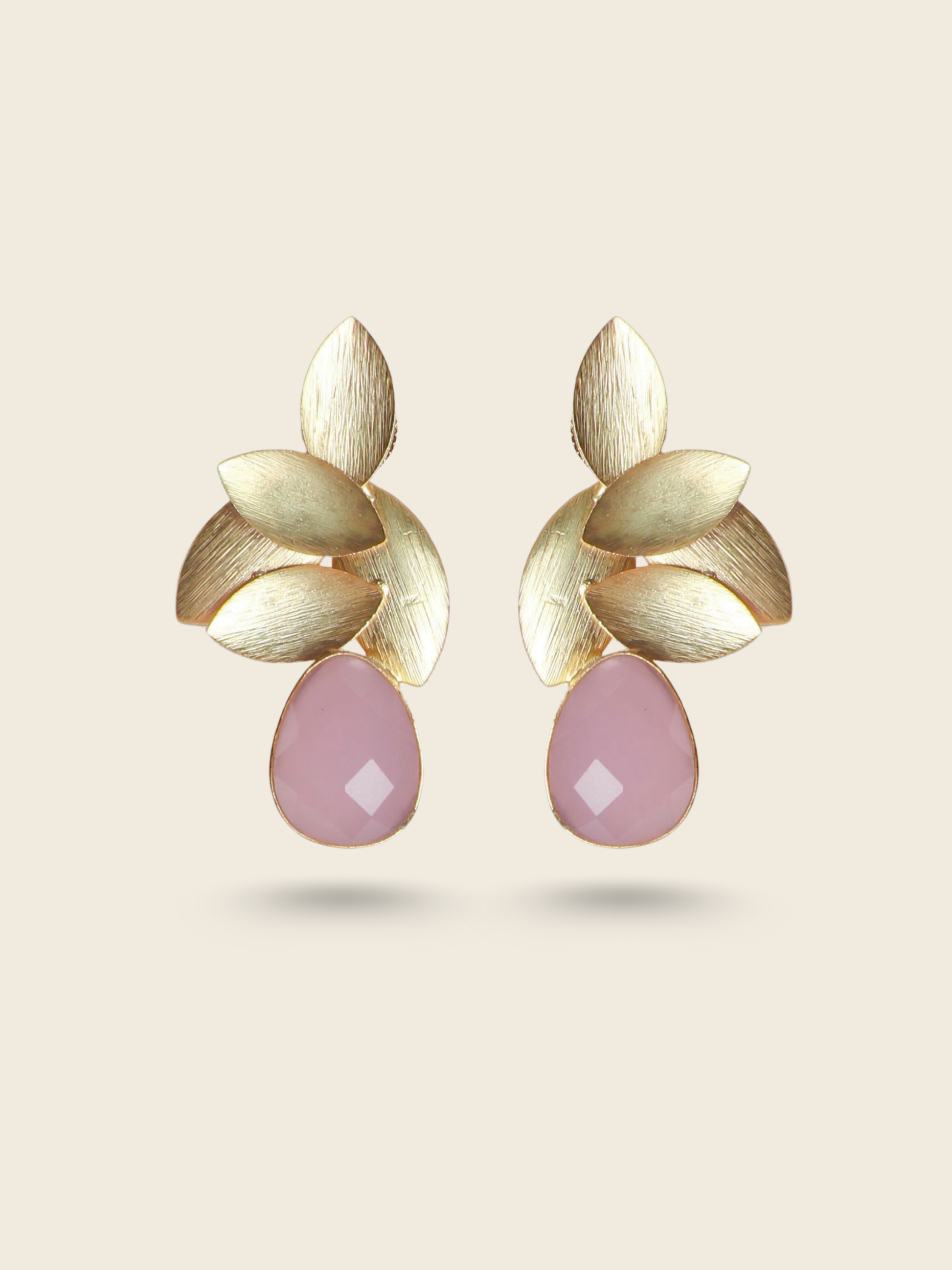 Elegant gold-toned leaf design earrings with pink teardrop stones, perfect for a chic and modern ethnic look.